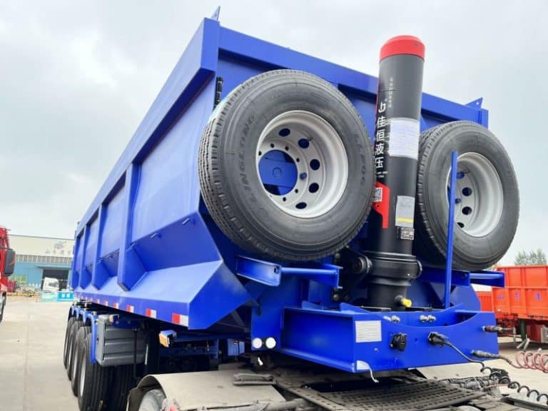 Detailed image of the Genron 4-axle end tipper trailer spare wheel carrier and hydraulic lift cylinders